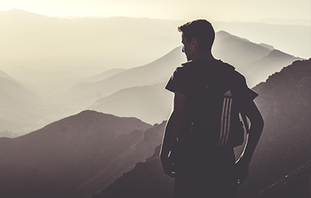Man hiking with bright sunlight